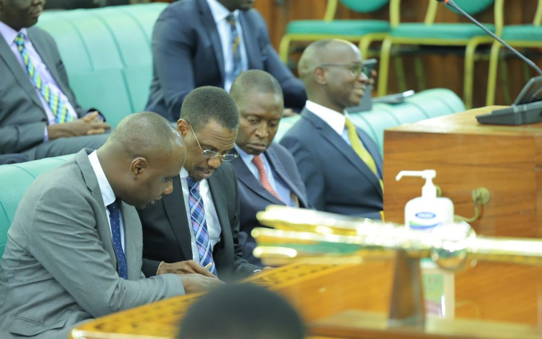 The Minister of State for Finance (General Duties), Hon. Henry Musasizi (left), the Attorney General, Kiryowa Kiwanuka and the Minister of State for Industry, Hon. David Bahati consult during the sitting of the House on Thursday, 16 May 2024